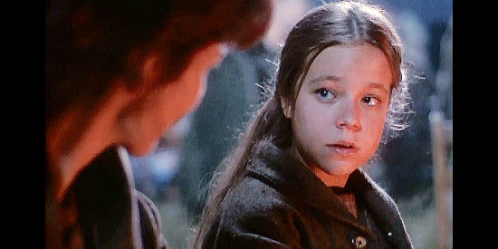 Tina Majorino as young Euphemia, fleeing Santa Ana's forces with her older sister Sarah McClure in True Women (1997)