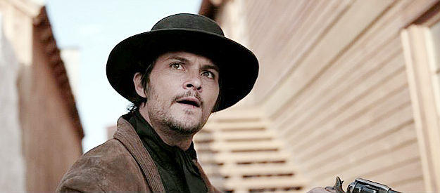 Shiloh Fernandez as Boots Miller, a member of the James McCallister gang in The Old Way (2023)