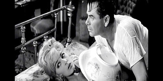 Stella Stevens as Mary Lou Williams and Glenn Ford as Jared Heath, startled by a knock on her door in Advance to the Rear (1964)