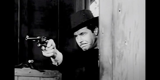 James Craig as Tobias Simms, springs into action during a train robbery in The Man from Texas (1948)