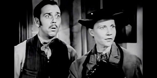 King Donovan as bank employee Sam and Una Merkel as Widow Weeks, surprised by a bank customer in The Man from Texas (1948)