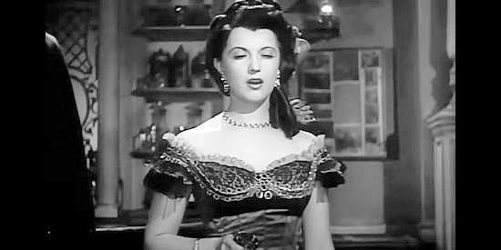 Margia Dean as Lolita, pulling her derringer to protect the Abilene Kid in Rimfire (1949)