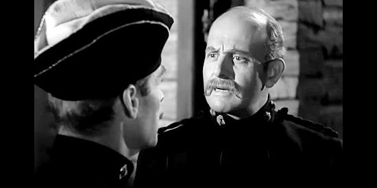 Moroni Olsen as Superintendent Andrew Standing, consulting Montague over potential Indian trouble in Susannah of the Mounties (1939)