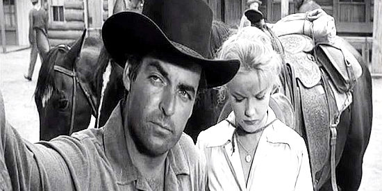 Rory Calhoun as Gil McCord, delivering a convicted killer to justice in The Hired Gun (1957)