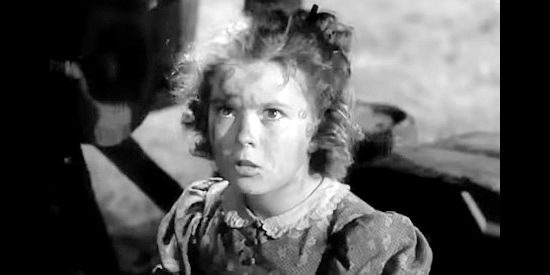 Shirley Temple as Susannah Sheldon, being discovered as the lone surivor of an Indian attack in Susannah of the Mounties (1939)