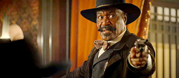 Delroy Lindo as Bass Reeves, attempting to take Nat Love into custody in The Harder They Fall (2021)