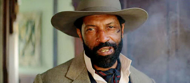 Deon Cole as Wiley Escoe, the man who ran Redwood until Rufus Buck returned to town in The Harder They Fall (2021)