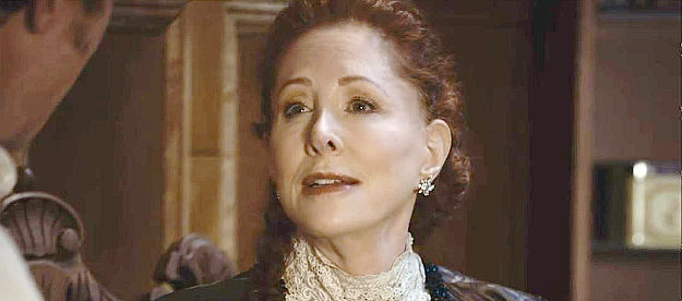Diana Golden as Madam Gabi, offering a hefty sum to purchase Angel in Bordello (2023)