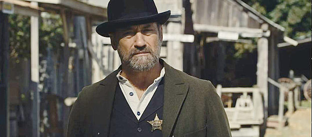 Frank J. Zupancic as Sheriff Amshell, the lawman who wants a cut of everything in Bordello (2023)
