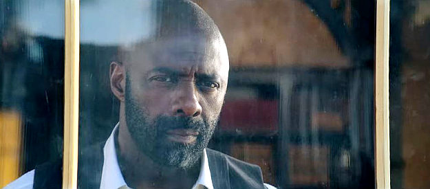 Idris Elba as Rufus Buck, watching his enemies ride into Redwood in The Harder They Fall (2021)