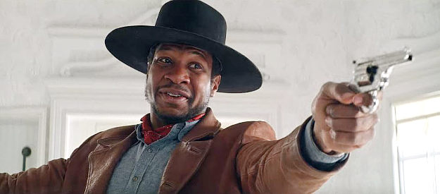 Jonathan Majors as Nat Love, holding up a bank in all-white Maysville in The Harder They Fall (2021)