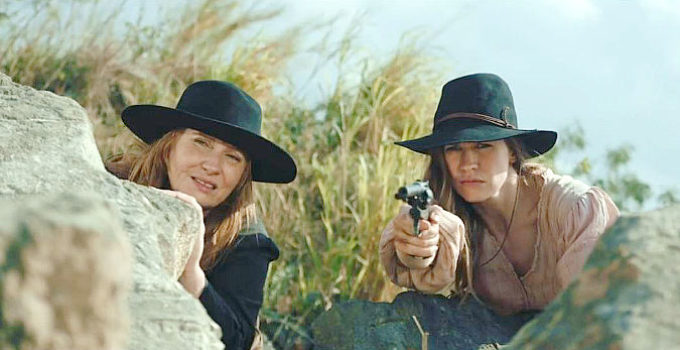 Heidi von Palleske as Ada and Camille Stopps as Tara, watching for an approaching posse in Bordello (2023)