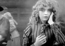 Lillian Gish as Melissa Harlow frets about what's happened to her child while the men try to defend the ranch house in The Battle of Elderbush Gulch (1913)