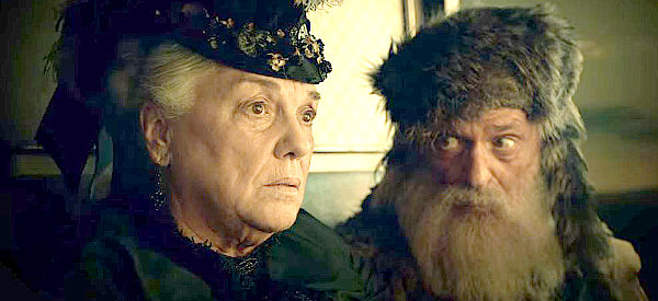 Tyne Daly as The Lady and Chelcie Ross as the Trapper, debating views on humanity in The Ballad of Buster Scruggs (2018)