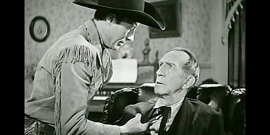 Bill Elliott as Wild Bill Boone, pretending to give Jeb Brandon (Carl Stocksdale) a rough time in The Return of Daniel Boone (1941)