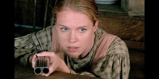 Erin Cottrell as Missie Davis, ready to defend her cabin as a rider approaches in Love's Long Journey (2005)