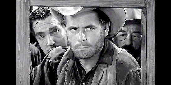 Glenn Ford as Jacob Walz, making the first deposit from the gold mine he found in Lust for Gold (1949)