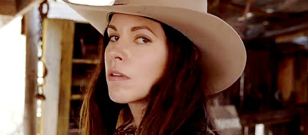 Lisa Barnes as Belle MacLure, a female bounty hunter known for her red boots in For the Reward (2022)