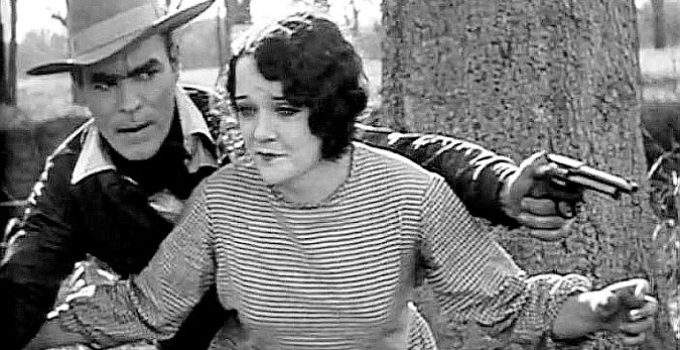Doris Chadwick as Mary Merrell, helping Harry Tracy (Jack Hoey) escape a lynch mob in Tracy the Outlaw (1928)