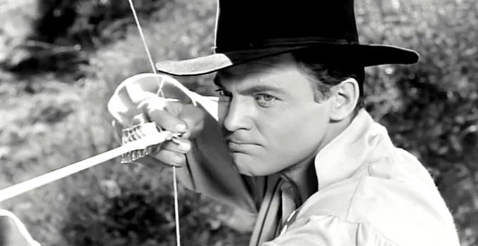 John Agar as Johnny Rush, learning to use a bow and arrow in The Lonesome Trail (1955)