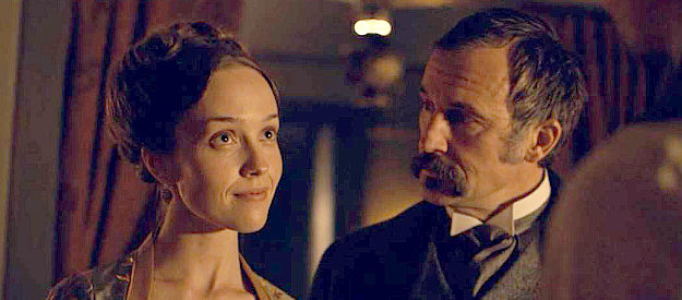 SIobhan Williams as Irene, smitten with Billy as husband Riley (Shaun Benson), one of Murphy's henchman, looks on in Billy the Kid (2022)