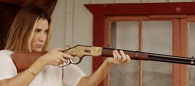 Sophia Okonsky as Mrs. Clayton, ready to defend the Clayton ranch in For the Reward (2022)