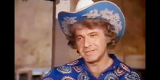 Dick Shawn as flamboyant singing cowboy Marshal Bing Bell, meeting Betsy in Evil Roy Slade (1972)