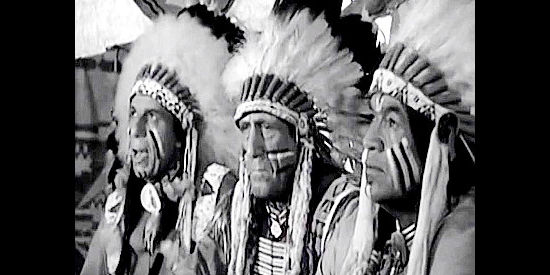 Arapahoe chiefs Red Rock (Iron Eyes Cody), Antelope (John Miljan) and Arrow (Charles Soldani) listen to Jim Henry's plea for peace in The Wild Dakotas (1956)