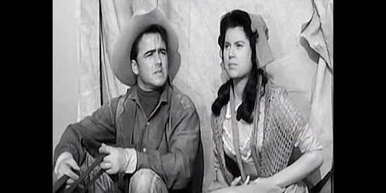 Dickie Jones as Mike McGeehee and Lisa Montell as Ruth Murphy, wary of the smoke signals they're seeing in The Wild Dakotas (1956)