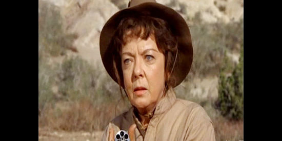 Ida Lupino as Martha Lindstrom, cleaning her six-shooter in Female Artillery (1973)