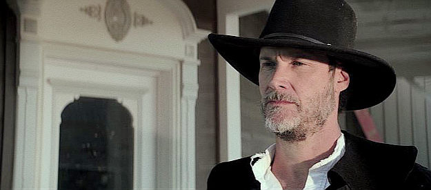 Randall Batinkoff as Sheriff Winters, realizing the mayor might have a special interest in the new arrival in town in Dead Man's Hand (2023)