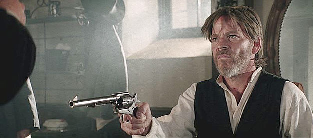 Stephen Dorff as Col. Clarence T. Bishop, holding a U.S. Marshal at gunpoint in Dead Man's Hand (2023)