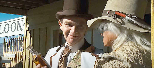 Woodrow Parfrey as Percy Long, trying to sell snake oil to Lone Watie in The Outlaw Josey Wales (1976)