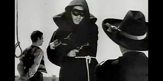 Abel Salazar as The Coyote, holding a gun on Capt. Potts to rescue Artigas from a date with a noose in The Coyote (1955)
