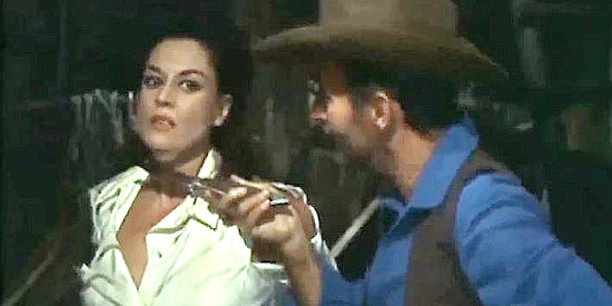 Alfredo Mayo as Slim, threatening to slice up Mabel if she doesn't comply with his demands in The Magnificent Brutes of the West (1964)