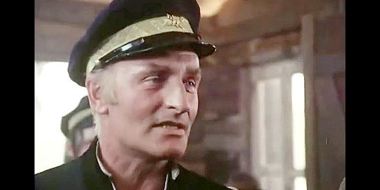 Anton Diffring as Lt. Slade, commander of a small detachment at the isolated outpost in Montana Trap (1976)