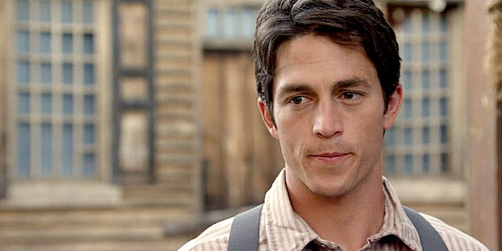 Bobby Campo as Erik Johnson, the outlaw's son taken in by the Davis family and the young man who falls for the mayor's daughter in Love's Christmas Journey (2011)