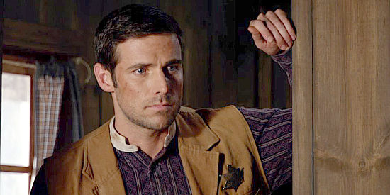 Dylan Bruce as Michael Strode, the deputy who falls for the sheriff's sister in Love's Christmas Journey (2011)