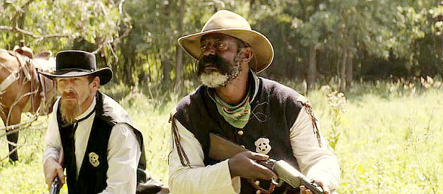 Isaiah Washington as Bass Reeves (right) and Jason Johnson as Sam Tanner trying to set up an ambush for the Jack Donner gang in Corsicana (2022)