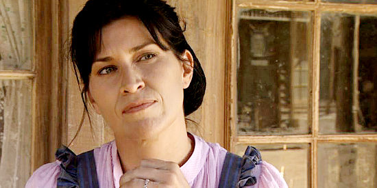 Nancy McKedon as shopkeeper Millie, considering a proposal from the sheriff in Love Begins (2010)