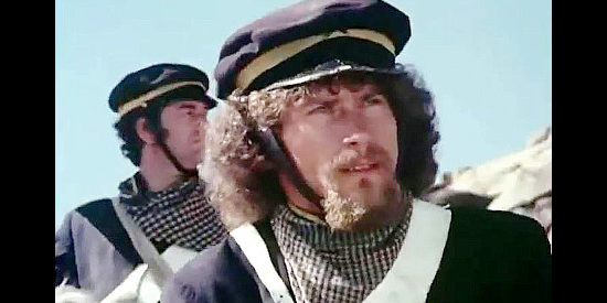 Paul Breitner as Sgt. Stark, part of the relief column sent to help the settlers in Montana Trap (1976)