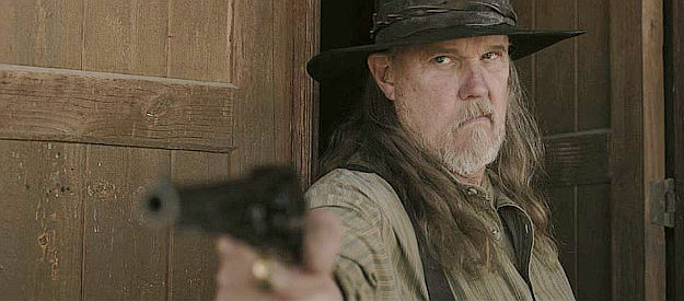 Trace Adkins as Michael, encountering strangers on his ranch in Among Wolves (2023)