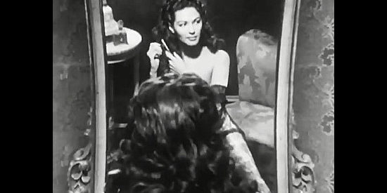 Yvonne De Carlo as Adelaide McCall, preparing for the arrival of a male admirer in The San Francisco Story (1952)