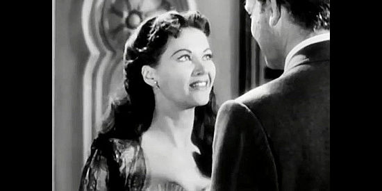Yvonne De Carlo as Adelaide McCall, turning on the charm for Rick Nelson (Joel McCrea) in The San Francisco Story (1952)