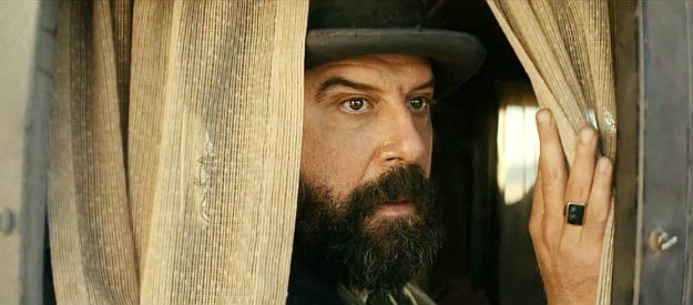 Brett Gelman as Mr. Fields, watching a gang of bandits approach the stagecoach in Surrounded (2023)