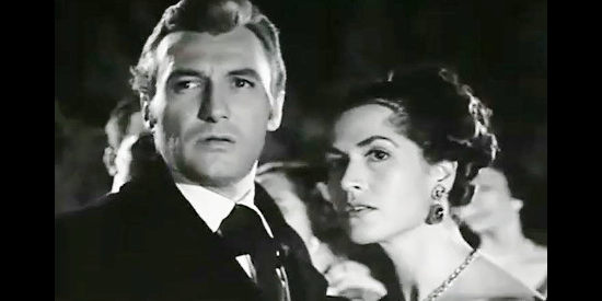 Manuel Monroy as Edmund Greene with the daughter of Don Ceasar de Echague, startled at a party in Judgment of Coyote (1956)
