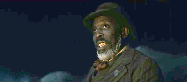Michael Kenneth Williams as Will Clay, the bounty man looking to form an alliance with Mo Washington in Surrounded (2023)