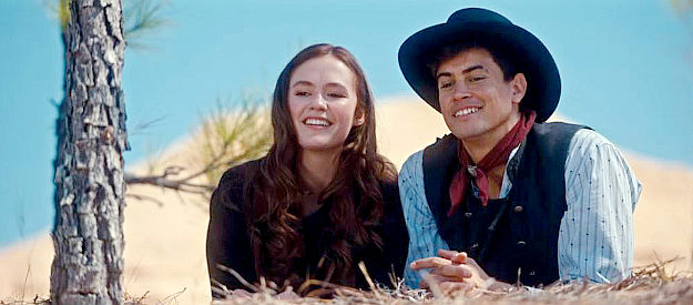 Olivia Sanabia as Hope Jacobs and Eric Stanton Betts as The Diamond Kid, enjoying a light-hearted moment in Birthright Outlaw (2023)