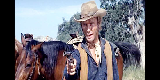 Paul Carr as Shep Barrenger, pulling a gun on the posse's prey in A Man for Hanging (1972)