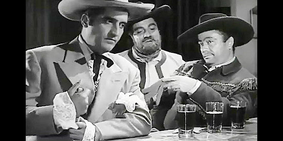 Two of Col. Clark's henchmen harass Cesar de Echague (Abel Salazar) on a visit to a local tavern in Judgment of Coyote (1956)